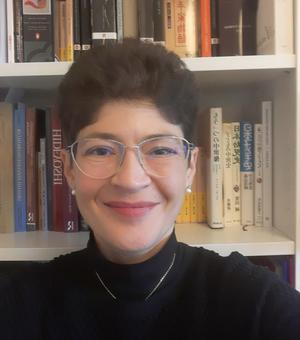 Dr. Pia Jolliffe against a background of books